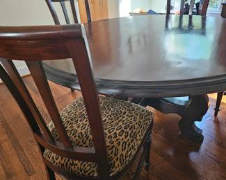 Round dining table with six chairs. Custom fabric seats. In excellent condition!