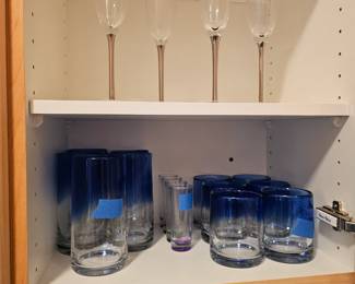 Nice of 4 champagne glasses on top.
Heavy blue glaze tumblers , high ball and shot glasses.