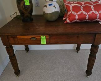 Antique oak table/desk on casters. In excellent condition!