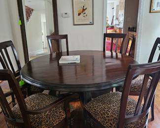A wonderful size! This round dining table has six chairs with custom fabric.