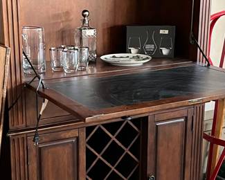 Portable bar with cabinets, shelves, and wine glass hanger