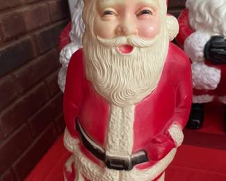 This blow mold Santa looks like he's been involved with a different kind of Christmas tree.