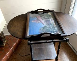 #66	Wood Drop-Side Tea  Cart on  Wheels w/top lift-up Display Tray (fits on top w/folded down sides) -38-18x30x28T  (as is finish w/puzzle under glass)	 $175.00 			
