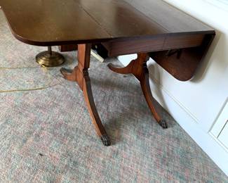 #105	Duncan Phyfe Drop-Side Table w/brass Feet 26-56 x 36x29T	 $75.00 			
