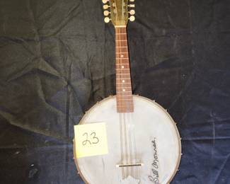 old banjolin with signature of Bill Monroe
