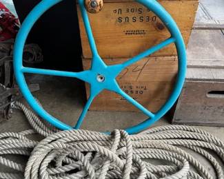 Antique boat steering wheel and heavy duty ropes