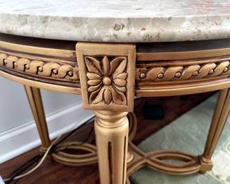 close up of wood carving on frame of marble side table