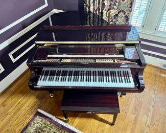 This Wurlitzer Baby Grand Piano with high polish mahogany finish plays like a dream!