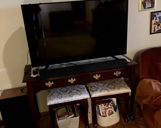 Large flat screen Sony. With a fairly new sound bar. Nice table and stools