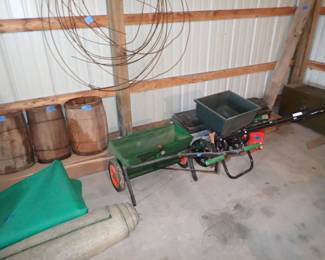 Barrels. Tarp. Fertilizer Spreaders. Gas Cans. Wood Tool Chest. Outdoor Carpet. 