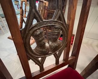 Close-up of the metal medallion on the seat backs of these chairs.
