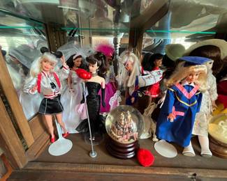 Several Barbie's.  These all have boxes.  The boxes will be placed in the same room as these collector dolls.