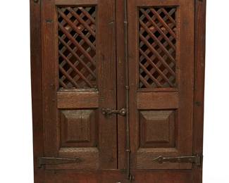160
18th/19th century
A Spanish Colonial Wood Cupboard
The wood cabinet with two lattice-front doors mounted on iron hinges with vertical bar locking mechanism, revealing an interior with two shelves, above a carved wood apron
46.5" H x 33.25" W x 11.25" D
Estimate: $1,500 - $2,500