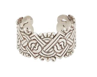 220
A William Spratling Mexican Silver Cuff Bracelet
William Spratling (1900-1967)
Circa 1940-1944, First Design Period; Taxco, Mexico
Stamped for William Spratling; further stamped: Mexico / Silver
A chased sterling silver cuff with interlaced Aztec-style motif and repoussé accents to edges
6.5" total inner C x 1.25" H, with a 1" gap
73.3 grams
Estimate: $600 - $800