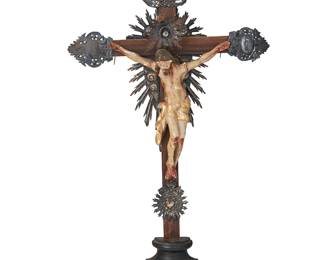 185
Late 19th century
A Latin American Wood And Silver Altar Crucifix
The wood cross with repoussé silver flourishes at the terminuses, one bearing the Titulus Crucis and one with mounted glass or stone accent centering a holy light medallion, above the mounted polychromed plaster Jesus figure, all mounted on a half-turned footed base
25.75" H x 14" W x 4" D
Estimate: $800 - $1,200