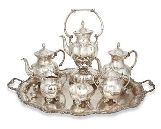 214
Mid-20th century
A Mexican Sterling Silver Coffee And Tea Service
Each stamped: CLS / Sterling 925 / Hecho en Mexico / [Eagle 141]
Comprising a coffee pot (9.25" H x 10" W x 5.75" D), a tea pot (9" H x 9.625" W x 5.875" D), a hot water kettle with chafing stand (15.125" H x 8.625" W x 7.325" D), a waste bowl (2.5" H x 4.25" Dia.), a lidded sugar bowl with opposed handles (6.625" H x 6" W x 4" D), and a creamer (4.75" H x 5.25" W x 4" D), all set on a tray (1.875" H x 27.5" W x 18" D), 8 pieces
255.1 gross oz. troy approximately
Estimate: $3,000 - $5,000