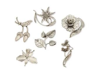 269
A Group Of Hector Aguilar Mexican Silver Floral Brooches
Hector Aguilar (1905-1986)
Circa 1940-1945; Taxco, Mexico
Each variously stamped: HA [conjoined] / 940 / Taxco / 990
Six sterling silver brooches in various floriform and foliate designs including acorns and pointsettia, 6 pieces
Largest: 3.125" H x 2.5" W; Smallest: 2" H x 2.25" W
138.4 grams
Estimate: $400 - $600