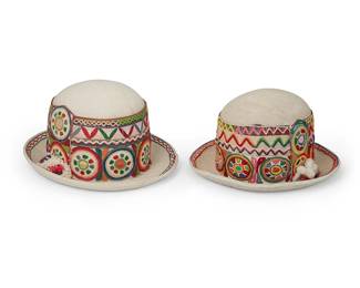 204
Early/mid-20th century
Two Bolivian Embroidered Felt Bowler Hats
The wool felt hats with stiff crowns, each brightly embroidered in banded wool and cotton with applied pompom flourish to one side, 2 pieces
Each: 5.75" H x 10.5" W x 11" D; Inner brim: 6.25" W x 6.75" D
Estimate: $200 - $400