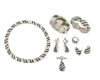 293
A Group Of Enrique Ledesma Mexican Silver And Hardstone Jewelry
Enrique Ledesma (d. 1979)
Circa 1955-1979; Taxco, Mexico
Each stamped: Ledesma / Taxco / 925 / Hecho en Mexico; further variously stamped: [Eagle 3] / [Design number] / Plateria Cortes
Seven works in sterling silver and stone inlay in green and blue comprising a narrow link necklace (16" L x 0.5" H), two chunky link bracelets with diagonal inlay (Larger: 7.25" L x 0.75" H; Smaller: 6.5" L X 1" H), as well as two pairs of earrings (Larger: No. 212; each: 2" H; Smaller: each: 1.25" H), a tie pin or collar brooch (1.875" H x 1.25" W) and a domed ring with diagonal inlay (Ring size: 7.5), 9 pieces
212.6 grams gross
Estimate: $400 - $600