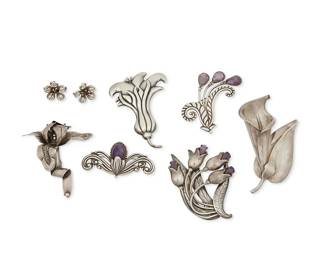 329
A Mixed Group Of Mexican Silver Jewelry
Mid-20th century
Each variously marked for maker, Sterling, Mexico, and design number
Six silver brooches in sterling silver including two Los Castillo brooches with floral and scroll motifs and set amethyst (Largest: No. 456P; 3" H x 3.5" W; Smallest: No. 700; 1.5" H x 1.125" W), a Los Castillo calla lily brooch (No. 610c; 4.5" H x 2.5" W), a Hector Aguilar floral spray brooch with amethyst accents (2.5" H x 3.5" W), and a Taller Borda repoussé silver flower brooch (3.875" H x 2.875" W), as well as a Victoria sculptural orchid brooch (3.25" H x 3.125" W) and a pair of Victoria silver floral earrings (Each: 1" Dia.), 8 pieces
230.1 grams gross
Estimate: $300 - $500