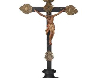 182
Late 19th century
A Latin American Wood And Silver Altar Crucifix
The ebonized wood cross with repoussé gilt silver flourishes at the terminuses, one bearing the Titulus Crucis, centering the mounted polychromed plaster Jesus figure, all mounted on a half-turned footed base
27.5" H x 14" W x 3.5" D
Estimate: $800 - $1,200