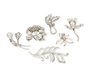 267
A Group Of Hector Aguilar Mexican Silver Floral Brooches
Hector Aguilar (1905-1986)
Circa 1940-1945, 1943-1948, 1948-1962; Taxco, Mexico
Each stamped: HA [conjoined] / 940 / Taxco; further variously marked: Made in Mexico / Sterling / [Eagle 9]
Six sterling silver brooches in floriform or foliate motifs in various styles including orchids, 6 pieces
Largest: 2.25" H x 5.25" W; Smallest: 1.75" H x 2.375" W
136.4 grams gross
Estimate: $500 - $700
