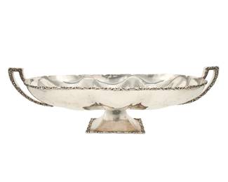 215
Mid-20th Century
A Juvento Lopez Reyes Sterling Silver Footed Centerpiece
Stamped for sterling and for Juvento Lopez Reyes, with indecipherable eagle assay mark
The oval bowl with lobed interior and opposed handles
7.875" H x 26.25" W x 12.5" D
80.3 oz. troy approximately
Estimate: $1,200 - $1,800