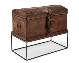 167
Late 18th century
A Spanish Colonial Wood Trunk
The wood trunk wrapped on four sides in leather with brass tacking, wrought iron banding and opposed lug handles, adorned at the front with four period padlocks, all set on a later added steel stand, 2 pieces
Trunk: 20.5" H x 37.75" W x 21" D; Stand: 13.75" H x 37.5" W x 19.75" D
Estimate: $500 - $700