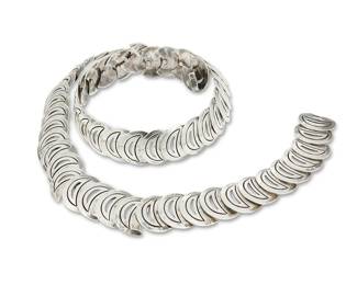 254
A Hector Aguilar Mexican Silver Link Belt
Hector Aguilar (1905-1986)
Circa 1948-1962; Taxco, Mexico
Stamped: HA [conjoined] / .940 / Taxco / Mexico / [Eagle 9]
A chunky sterling silver belt or necklace with incised openwork "half-moon" crescent links
32.5" L x 1.125" H
257.6 grams
Estimate: $800 - $1,200