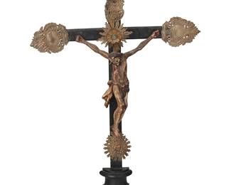 184
Late 19th century
A Latin American Wood And Silver Altar Crucifix
The ebonized wood cross with repoussé silver flourishes at the terminuses, one bearing the Titulus Crucis and one with mounted glass or stone accent centering a holy light medallion, above the mounted polychromed plaster Jesus figure, all mounted on a half-turned footed base
23" H x 14" W x 3.25" D
Estimate: $800 - $1,200
