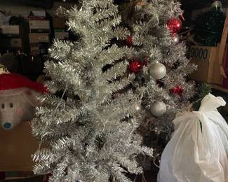 Small vintage Christmas trees. There are 6 foot aluminum Christmas trees available also in the box.