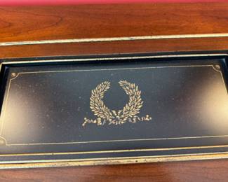 decorative black metal tray with gilt highlights                            22" w x 8" d