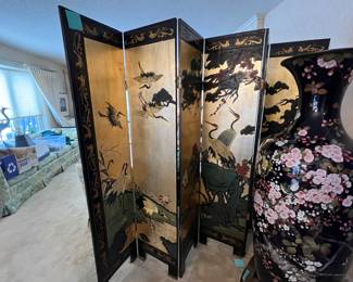 Japanese Meiji-era (1868-1912) 58" monumental cloisonné urn and 72x96 twentieth century Chinese export six-panel Coromandel gilt screen. The urn depicts birds within a plum tree in full bloom on a midnight blue background. The screen shows cranes and riverside landscape on a gilt background. The reverse has a simpler nature design against black lacquer. The two together delighted family and visitors for decades. Dramatic decoration for Asian art lovers! Contact us for a pre-sale viewing. $1000 each for the urn and screen. $1800 together.