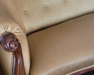 Close-up detail of carved wood & upholstered camelback settee