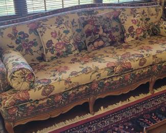 Upholstered sofa with carved wood  purchased by the homeowners in the early 1950's 