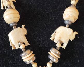 #60 bone necklace, 14", with carved bone pendant featuring elephants