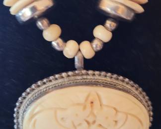 #60 close-up of carved bone pendant