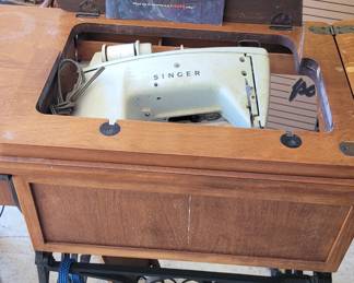 Antique sewing machine in table, with original Manual, belonged to the homeowner's Grandmother