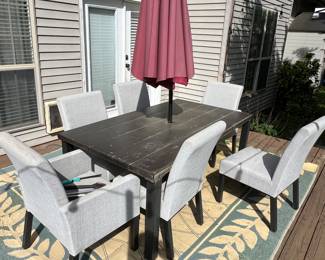 Outdoor patio set with upholstered chairs and rug