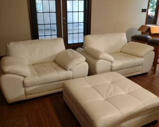 White leather comfortable chairs with ottoman. Matches the couch.