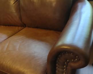 Brown leather couch with nail head accents