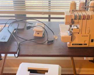 Baby Lock Serger with table and a basket of unused serger thread