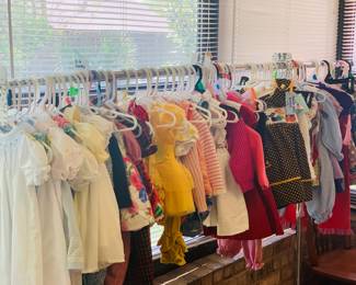 There is a room filled with Girl's Infant to 2T clothes, smoked dresses, shoes, toys, sleep gear, and blankets--very lightly used