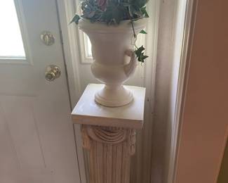 pedestal with a pot of fake greenery