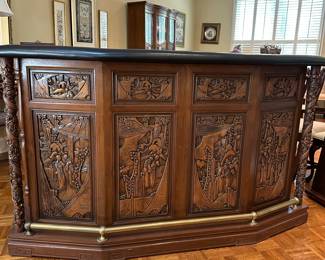 F14 - $750. Hand carved bar. Measures 22.5" deep x 6' wide x 43" tall. Brass foot rest across the bottom. Marble and Leather top. Needs minor repair to door on backside (new screws/wood glue to hold a hinge). Otherwise very good vintage condition. From China or Thailand. BUY IS RESPONSIBLE FOR MOVING. 