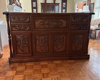 F14 - $750. Hand carved bar. Measures 22.5" deep x 6' wide x 43" tall. Brass foot rest across the bottom. Marble and Leather top. Needs minor repair to door on backside (new screws/wood glue to hold a hinge). Otherwise very good vintage condition. From China or Thailand. BUY IS RESPONSIBLE FOR MOVING. 