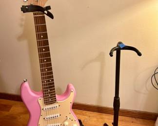Pink Fendor Squier Guitar w/ stand  $125
Small guitar stand $15
