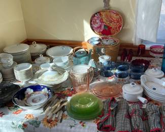 Antique dishes, depression glass, and assorted silverware.
