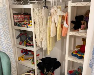 Closet of vintage and new toys and vintage baby clothes