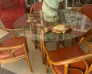 Glass top rattan table with leather upholstered chairs